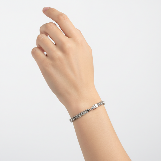 Silver chain bracelet on a textured gray surface
