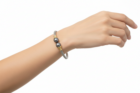 Bracelet with gray beads and gold accents on a light background