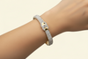 Gold bracelet with diamond accents .