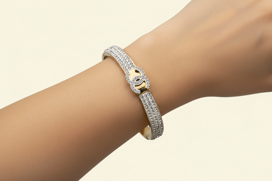 Gold bracelet with diamond accents .