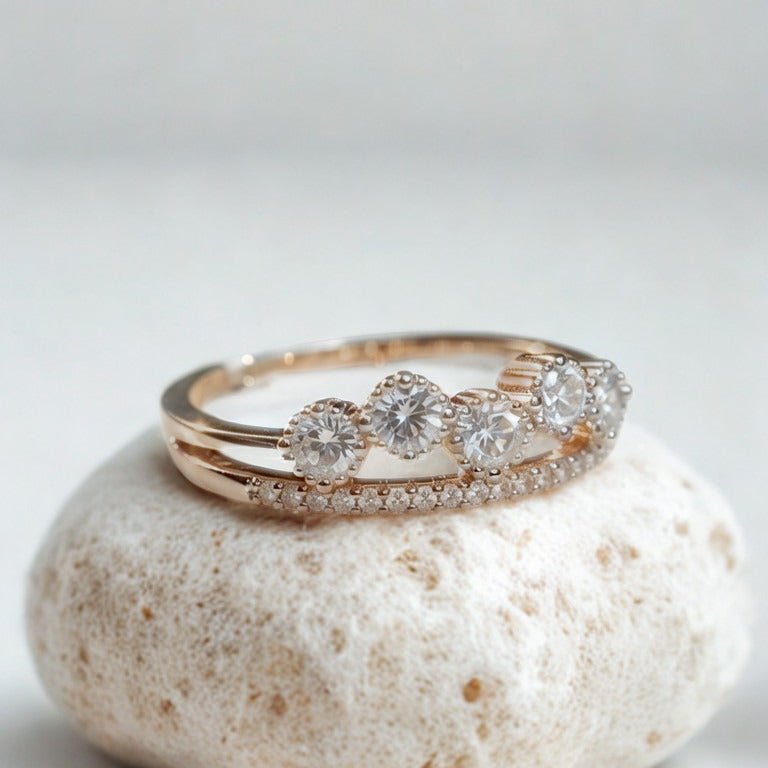 Rose gold ring with diamonds on a white stone