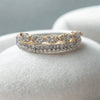 Silver ring with rose gold accents on a light gray background
