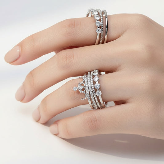 Silver rings with gemstones on a white marble surface