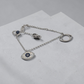 Silver bracelet with an eye-shaped pendant on a light gray surface