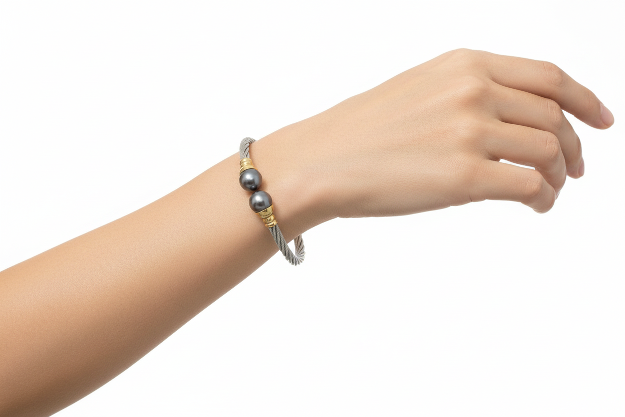 Bracelet with gray beads and gold accents on a light background