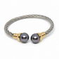 Bracelet with gray beads and gold accents on a gray background