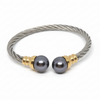 Bracelet with gray beads and gold accents on a gray background