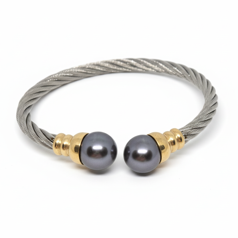 Bracelet with gray beads and gold accents on a gray background