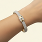 Gold bracelet with diamond accents .