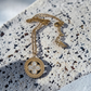 Gold necklace with a pendant on a textured surface