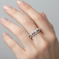 Diamond ring on a white cushion with a light gray background