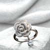 Silver ring with floral design and diamond on a white stone surface