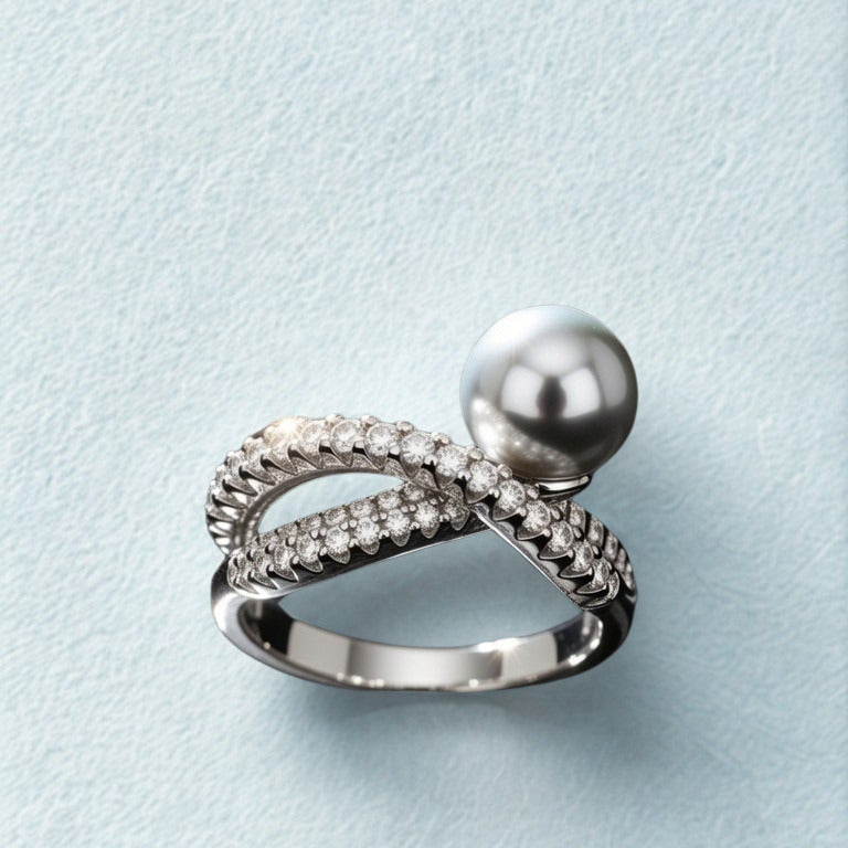 Silver ring with a pearl on a light blue background