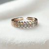 silver ring with embedded stones on a white stone surface