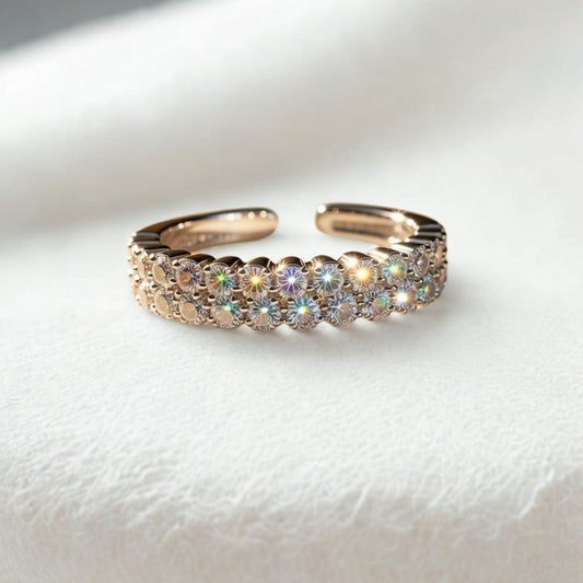 silver ring with embedded stones on a white stone surface