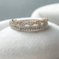 Silver ring with rose gold accents on a light gray background
