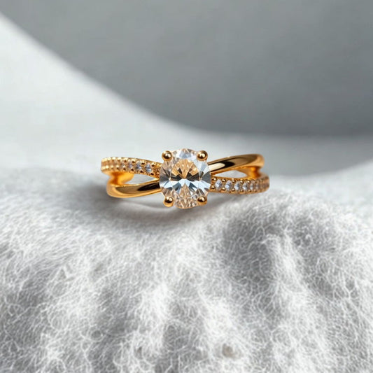 Gold ring with a diamond on a textured white surface