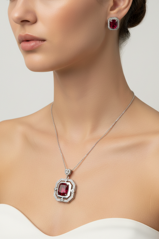 Jewelry set with red gemstones on a stone surface